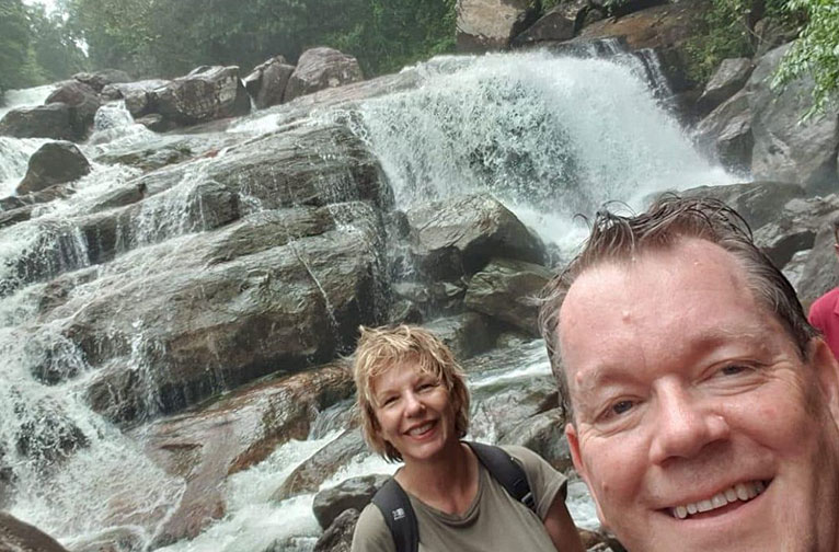 travellers enjoying water fall